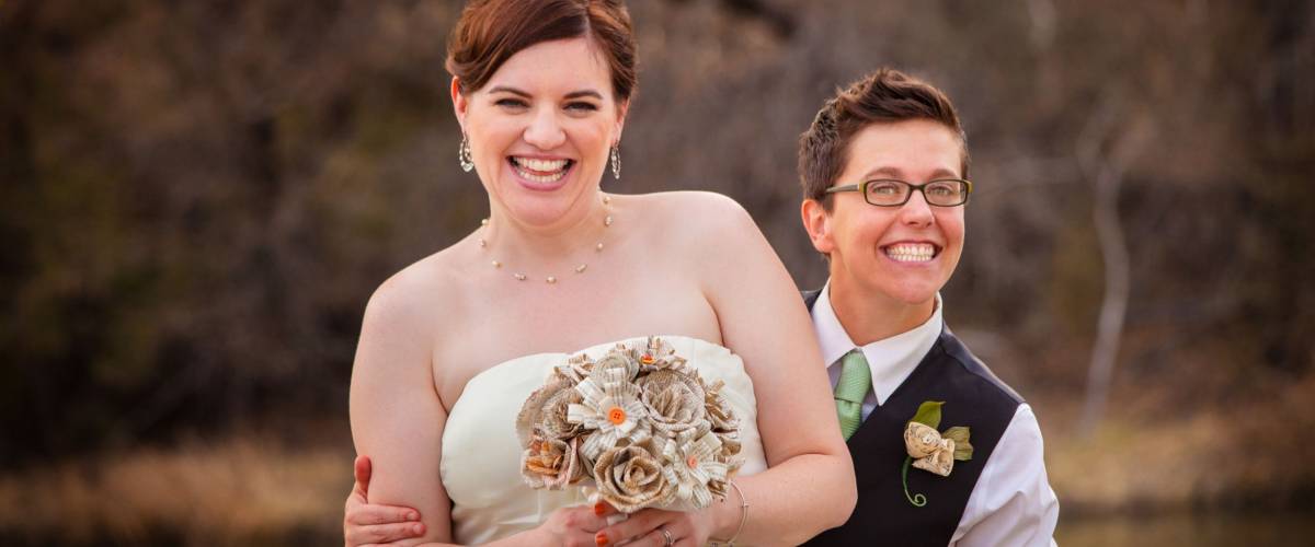 Cute newlywed gay couple laughing together