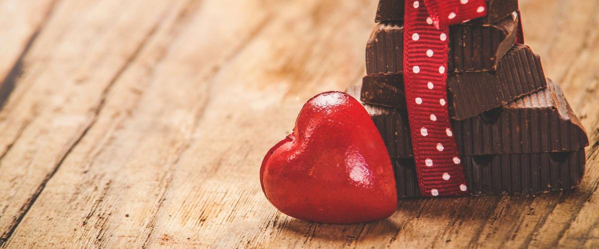 Chocolate with ribbon and heart on St. Valentine's day love.