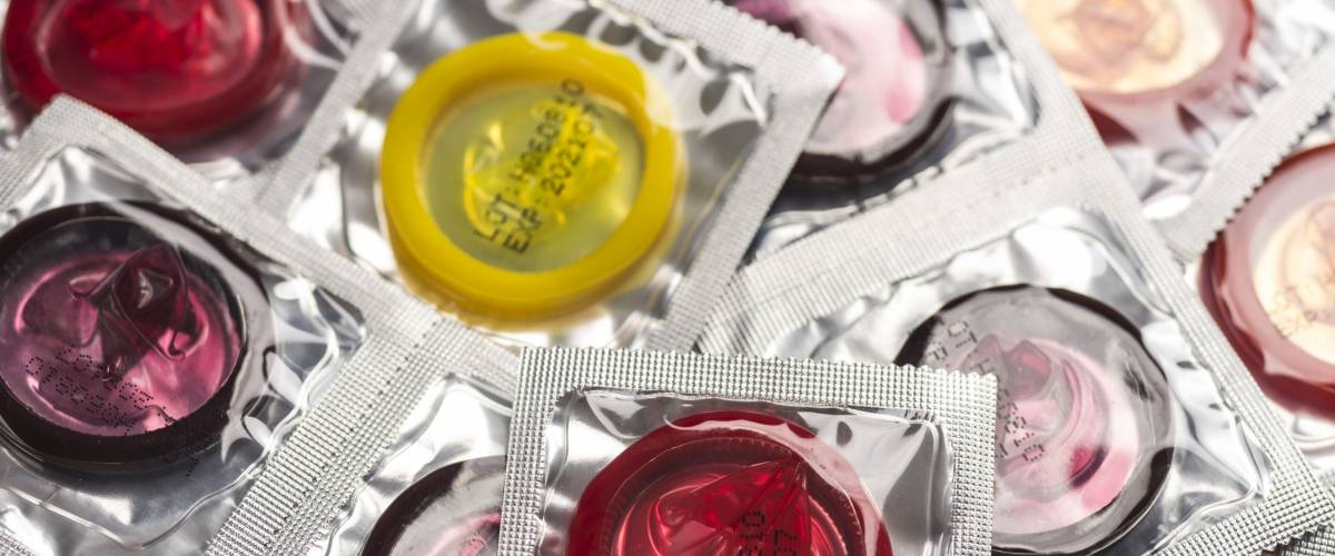 Close up shot of various colored condoms