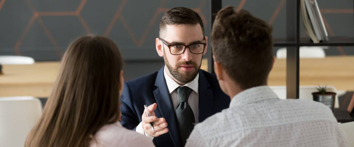 Couple interviewing broker