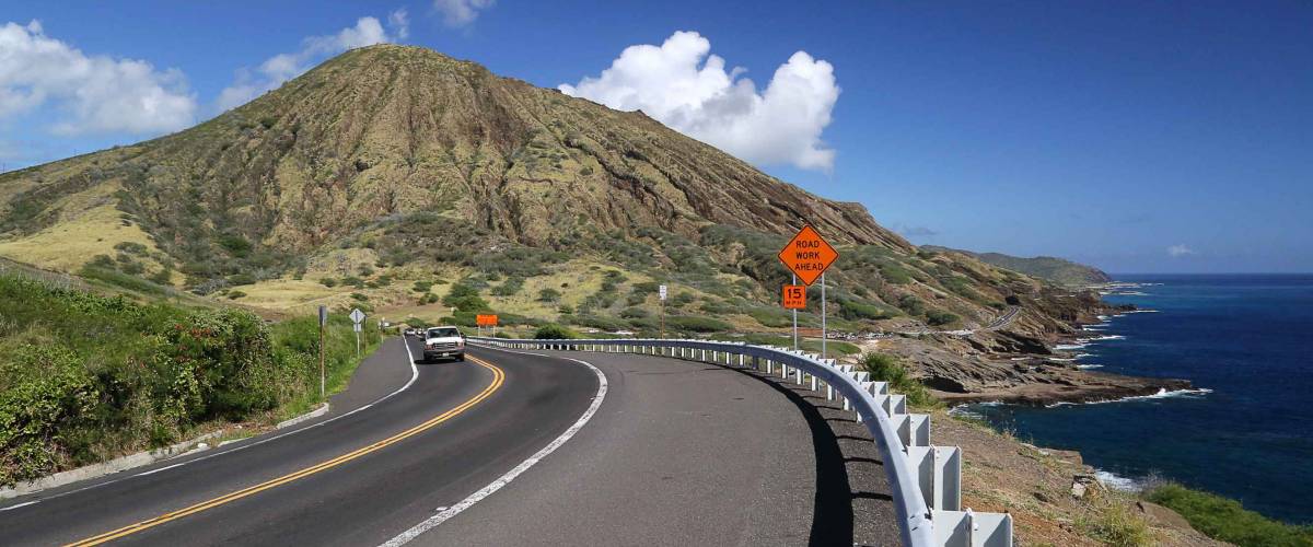 road coast sign hill clouds sunny day hawaii