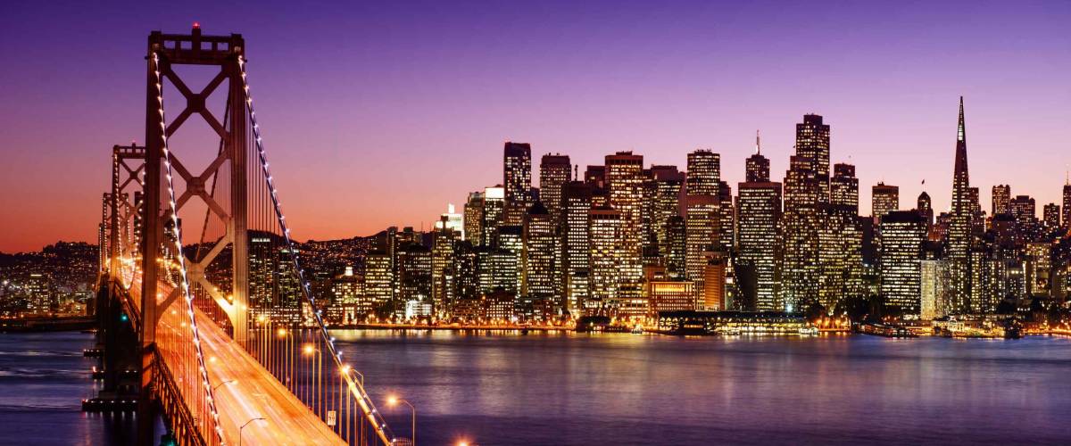 San Francisco skyline and Bay Bridge at sunset, California