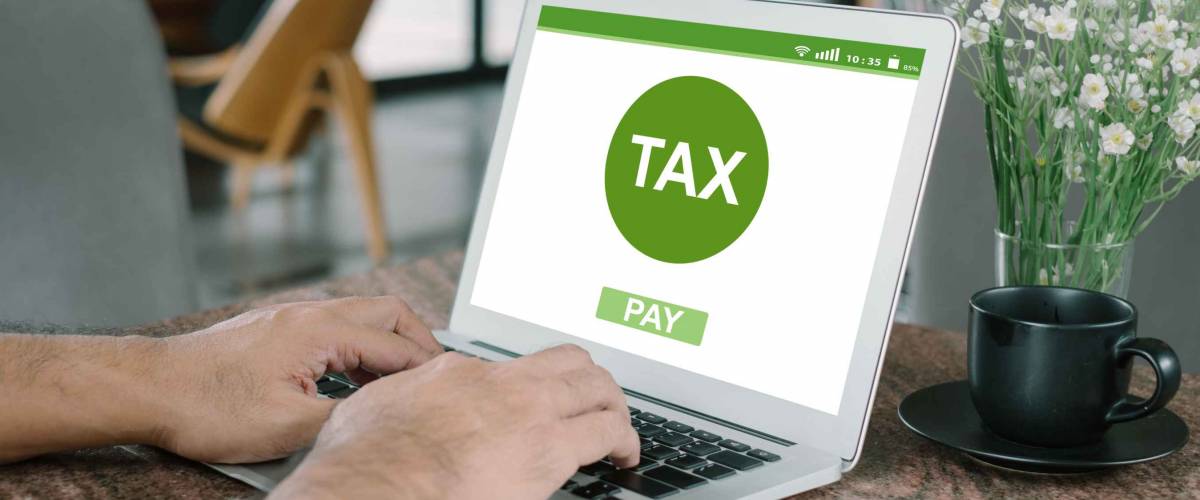 Filing taxes online using a laptop and the internet.
