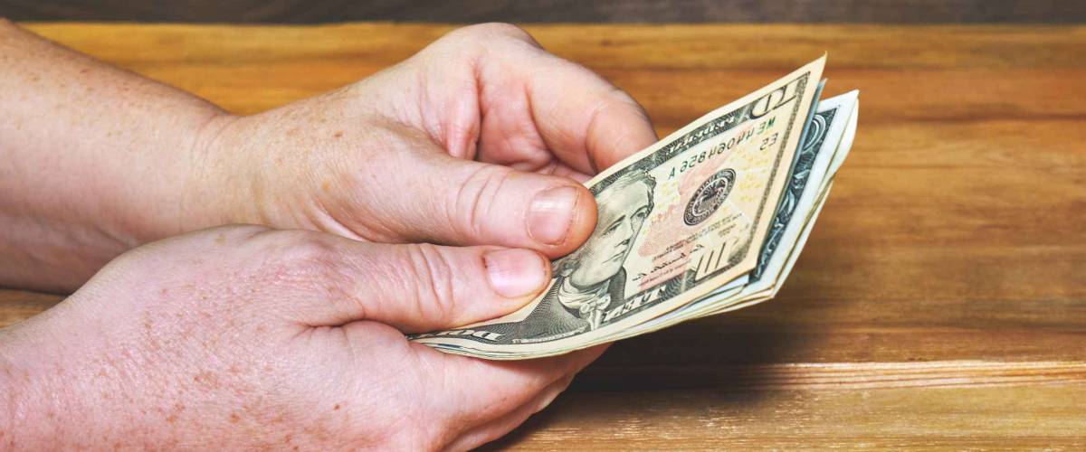 Close Up Male Hands Count Dollar Bills. Lack of money