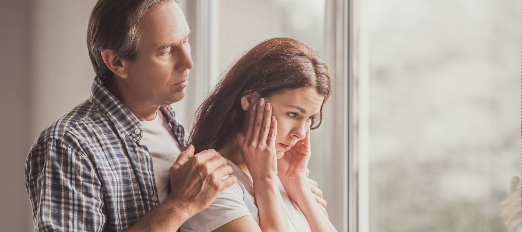 A couple at home, stressed.