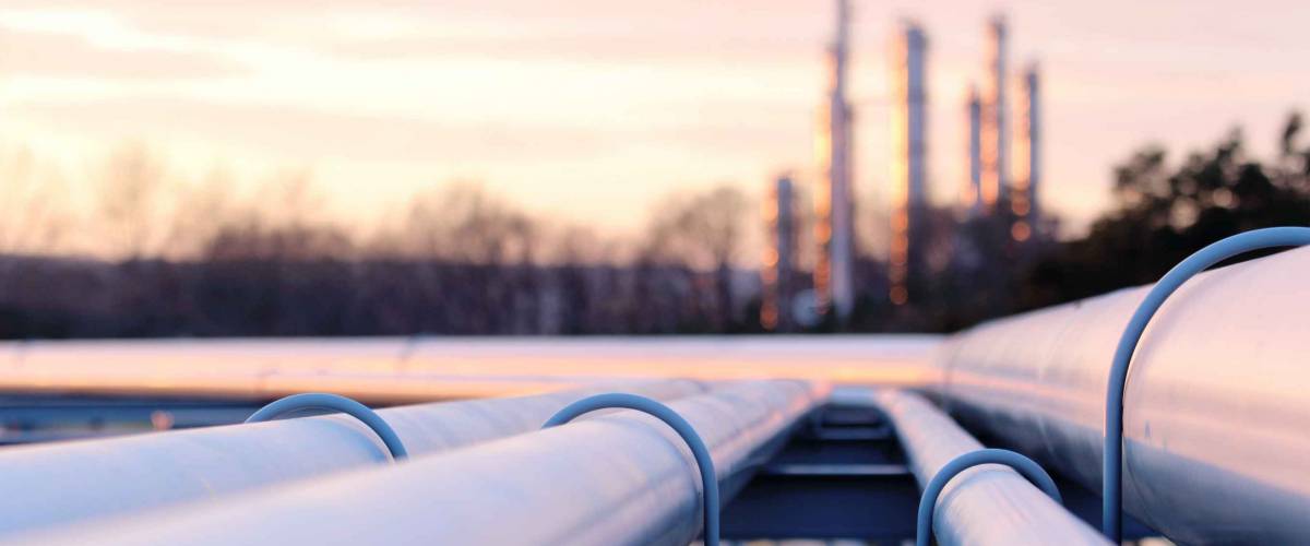 steel long pipes in crude oil factory during sunset