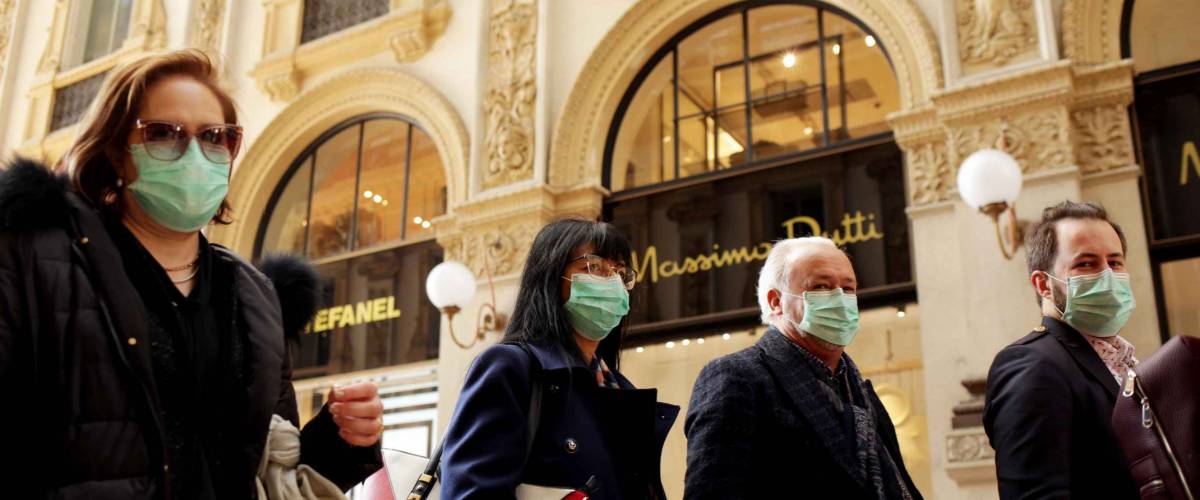 MILANO,ITALY- FEBRUARY 22, 2020: Coronavirus in Italy.Protective mask.Tourists in face masks at the Wiktor Emanuel II Gallery