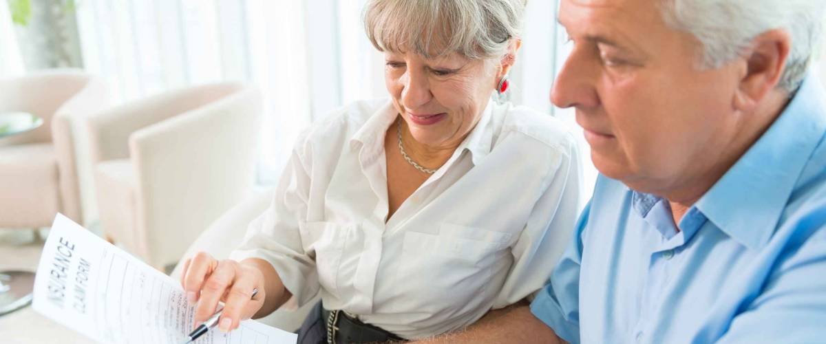 Elderly couple purchasing life insurance