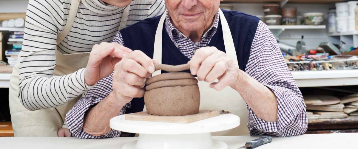 Senior Man With Teacher In Pottery Class
