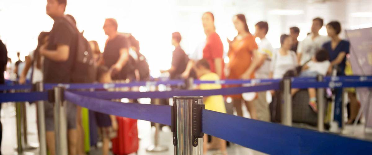 Passengers check-in line at the airport on vacation