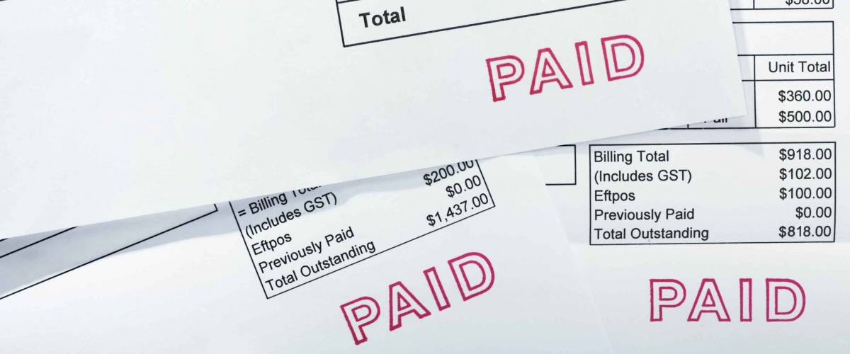 Three invoices for several thousand dollars, all with PAID stamp. These are normal bills, with folds and a few creases.