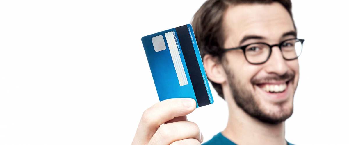 Happy man showing his new credit card