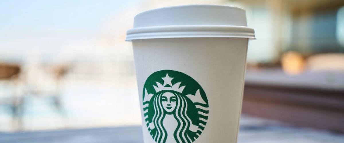 Starbucks up on wooden table