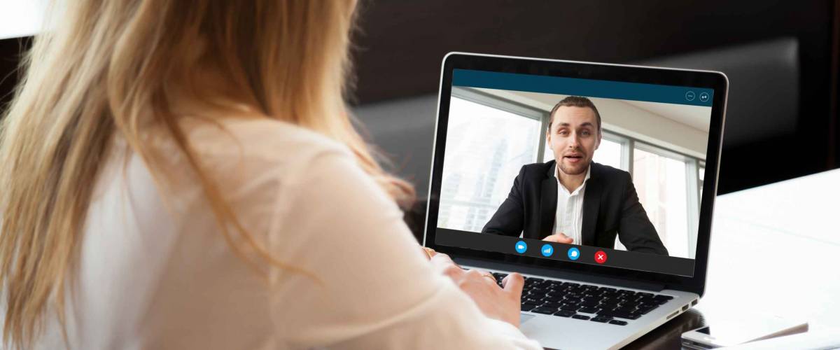 Businesswoman making video call to business partner using laptop