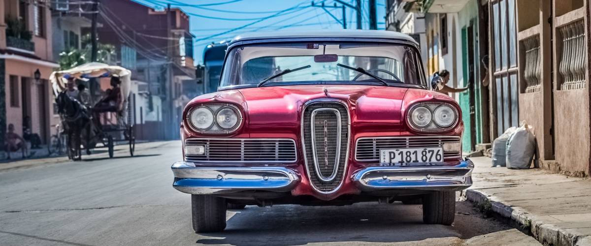 Santa Clara, Cuba - September 11, 2016: HDR - American red Ford Edsel classic car with white roof parked on the side street in Santa Clara Cuba - Serie Cuba Reportage