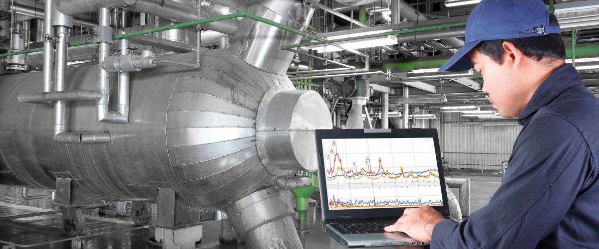 Technician use computer check for maintenance equipment and pipeline in a modern thermal power plant industrial