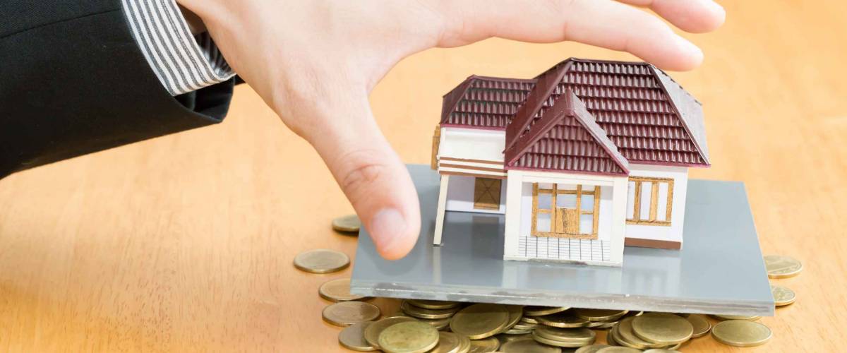 Hand reaches for home and money
