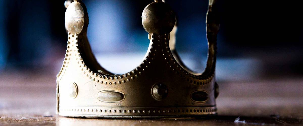 Close up of an isolated, worn out, plastic, gold-colored fake crown