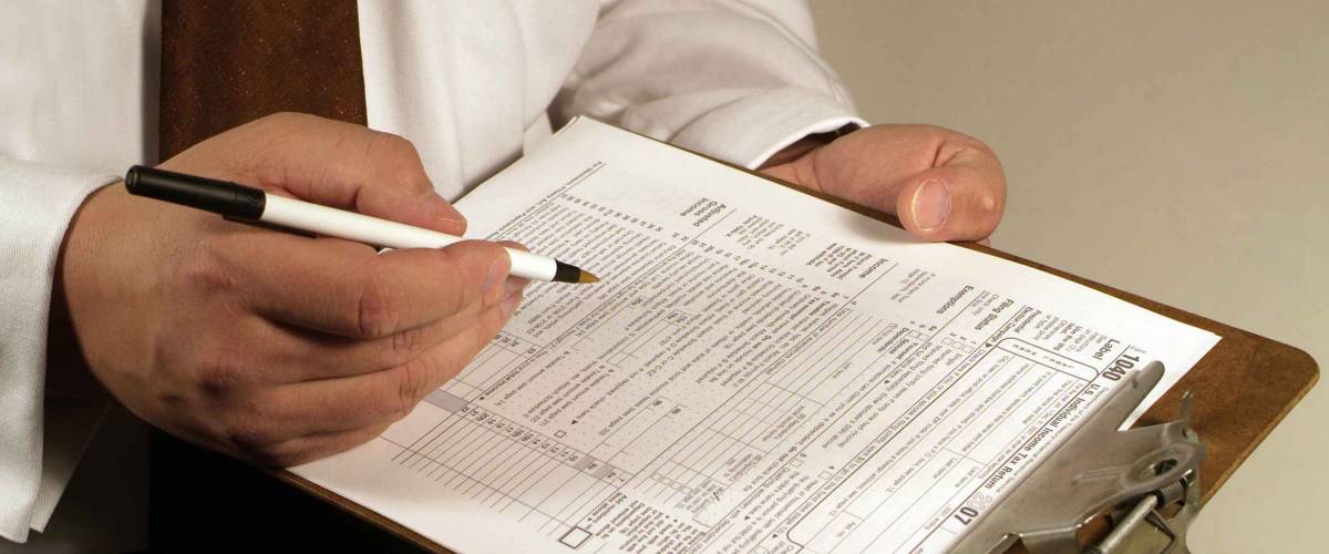 business man fills out a tax form