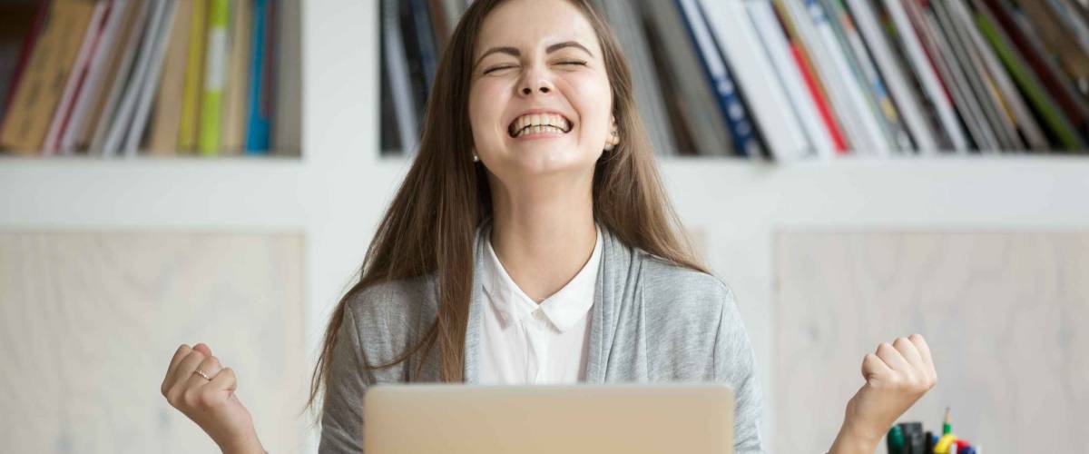 Excited female student celebrating job offer