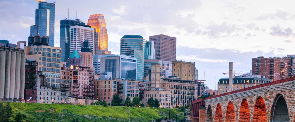 Downtown Minneapolis, Minnesota at night time as seen from the famous stone arch bridge