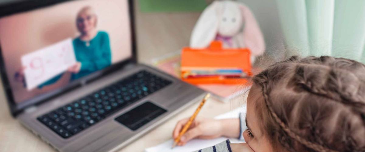Schoolgirl studying during her online lesson at home