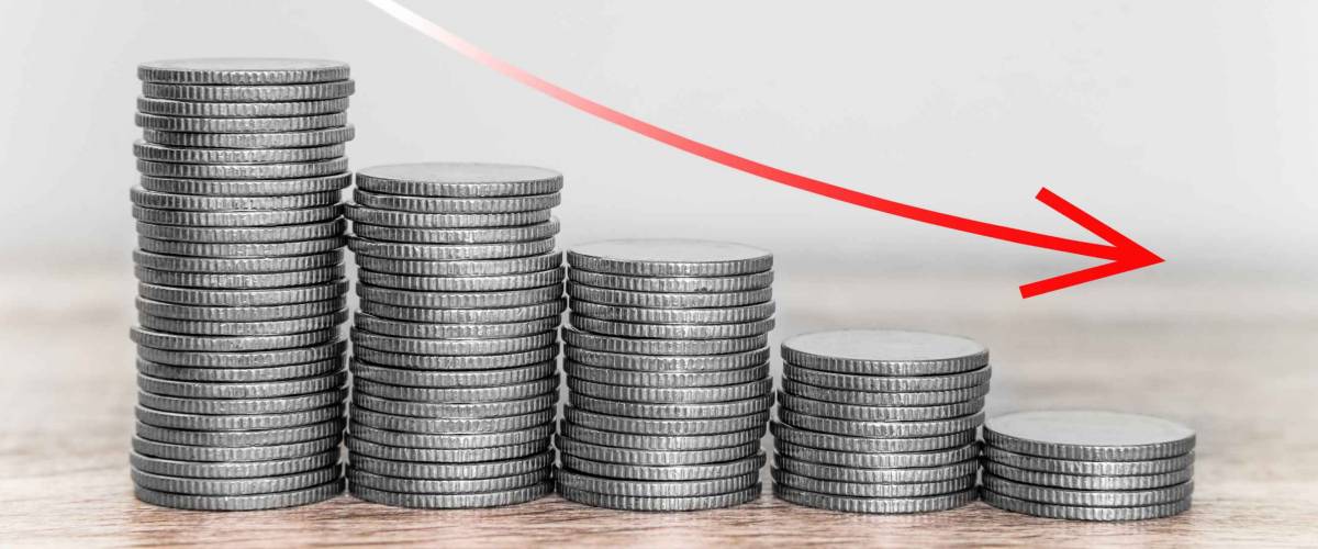 Red downward arrow with coins stacks background