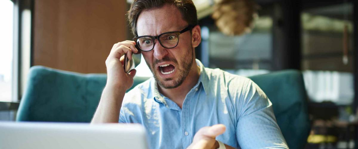 Experienced executive manager quarreling with employee on mobile yelling and screaming about bad report and failure with project, mad boss angry about software bugs in application for work