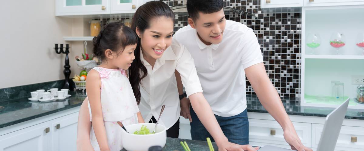 Family in the kitchen looking at life insurance policies
