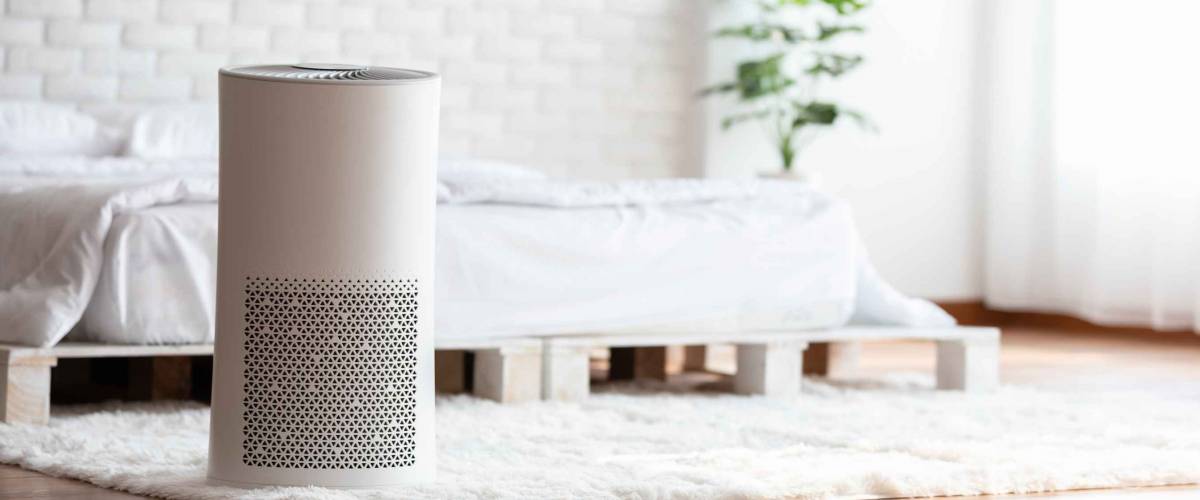 Air purifier in cozy white bed room for filter and cleaning removing dust PM2.5 HEPA in home,for fresh air and healthy life,Air Pollution Concept