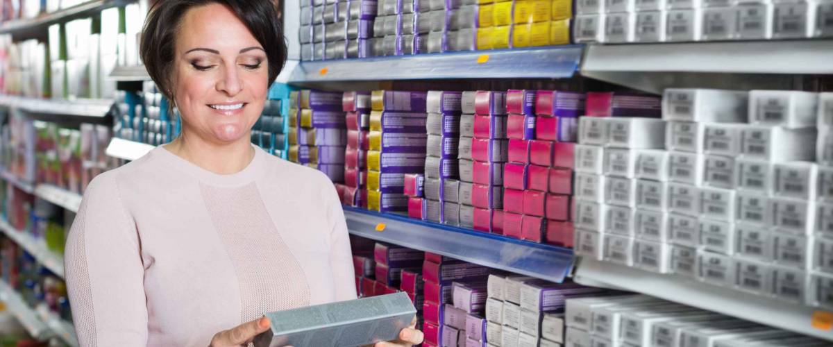 Adult brunette matching the hair dye color in the beauty store