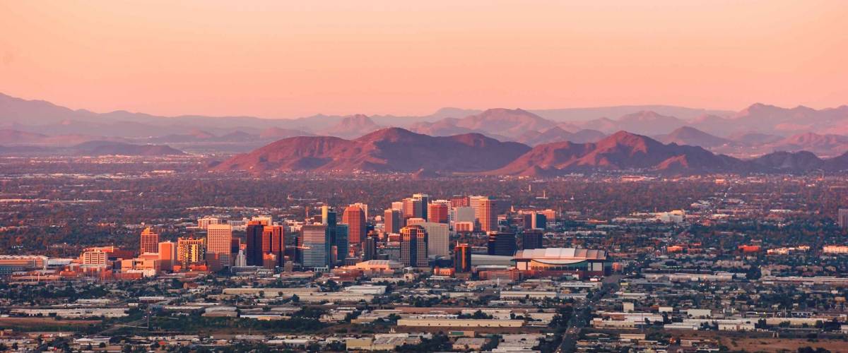 Phoenix Arizona with its downtown lit by the last rays of sun at the dusk.
