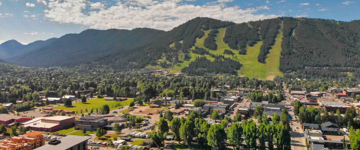 Panoramic aerial view of Jackson Hole homes and beautiful mountains on a summer morning, Wyoming.