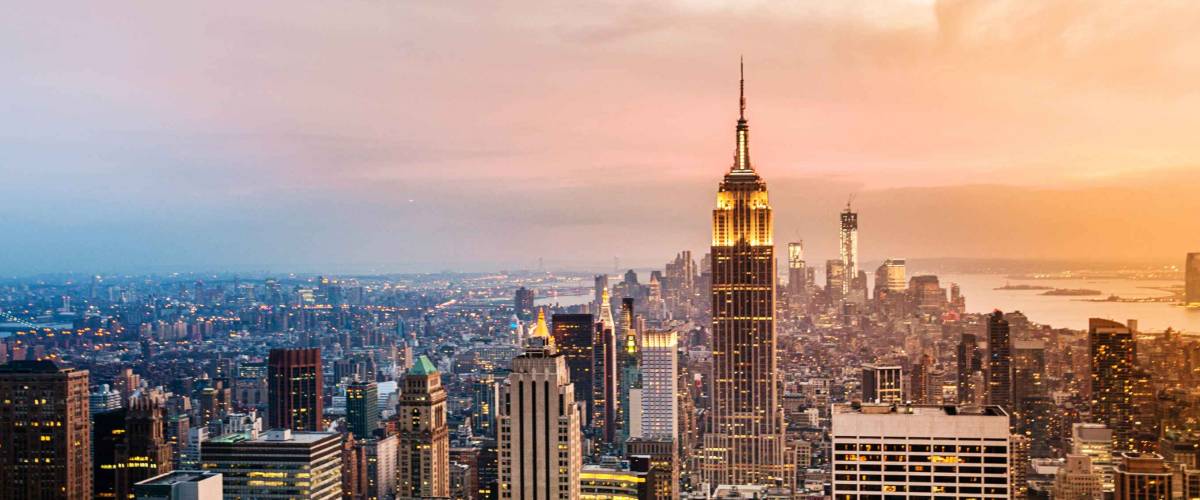 New York City skyline with urban skyscrapers at sunset.
