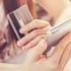 Close up of woman holding credit card and smartphone