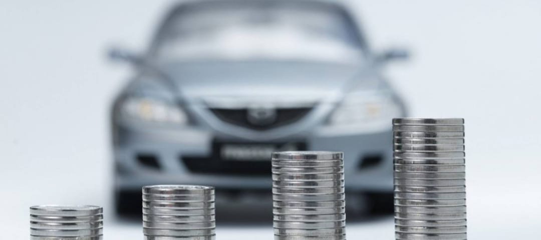 Vehicle parked behind stacks of coins