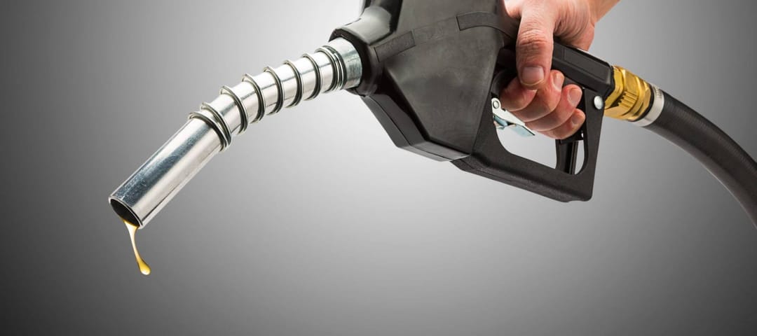 Money sticking out of automobile fuel tank opening signifying and illustrating the high cost of gas.