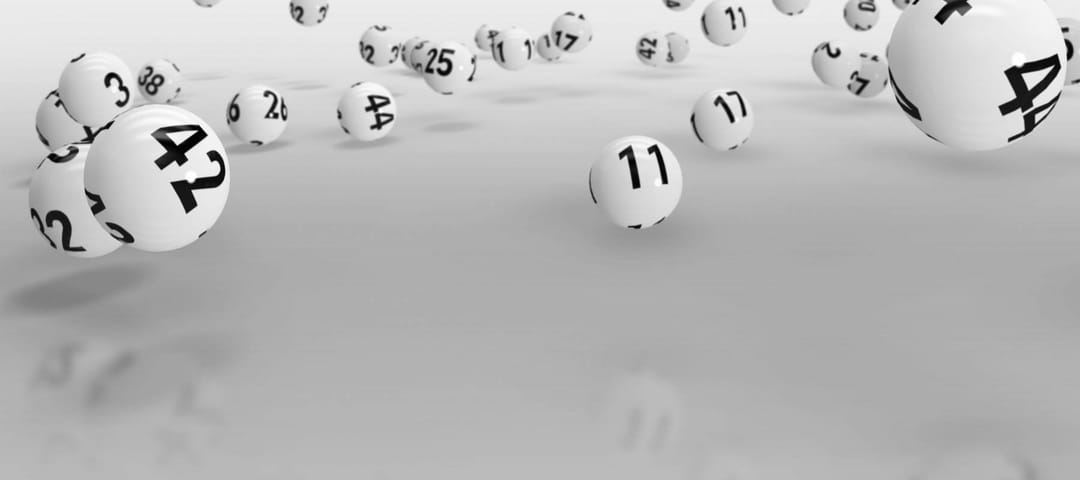 Falling lottery balls against grey background