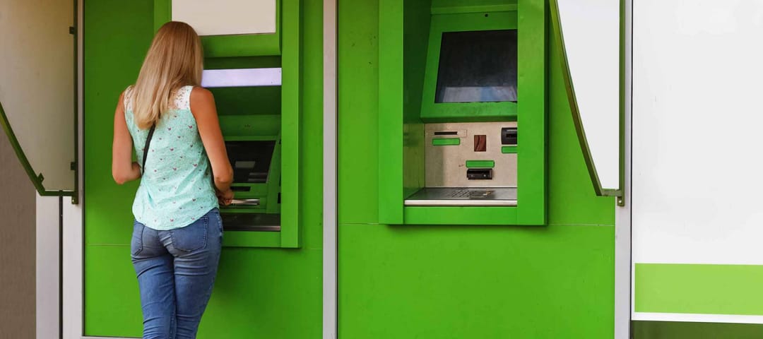 young woman using a cash point. Young girl using ATM