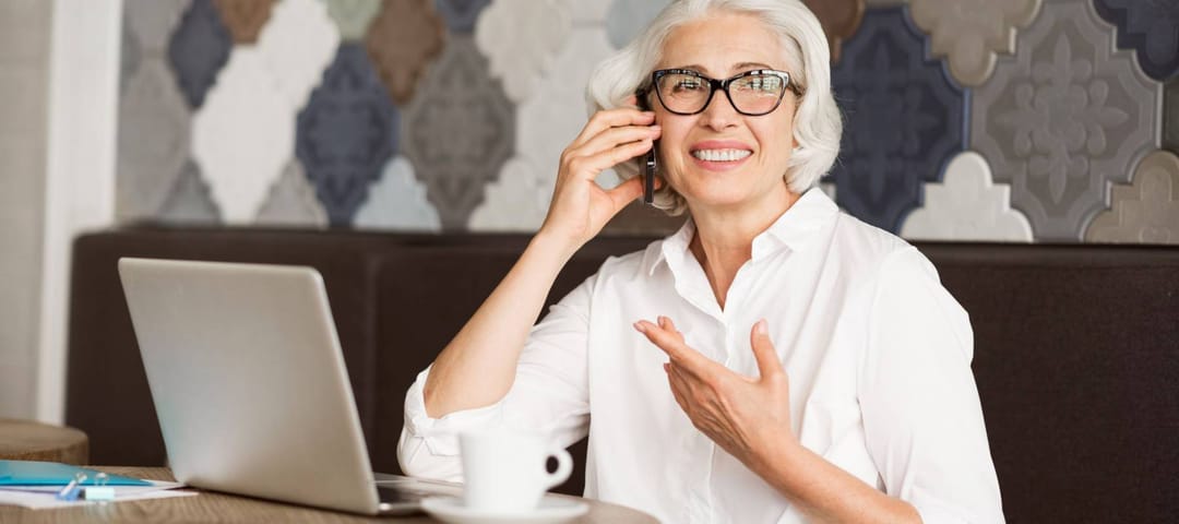 Cheerful senior woman talking on cell phone