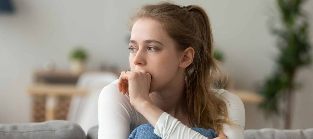 Head shot woman anxious worried millennial woman