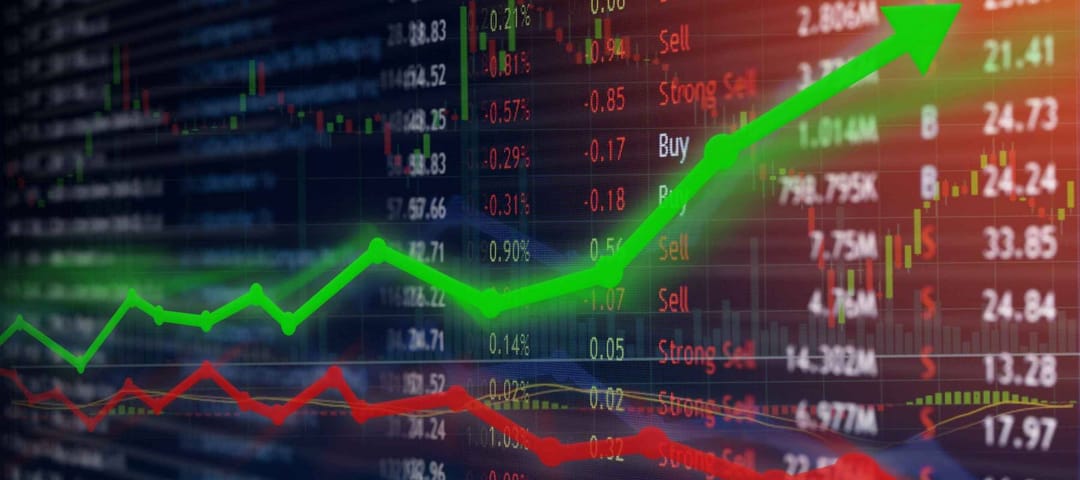 Investing and stock market concept gain and profits with faded candlestick charts.