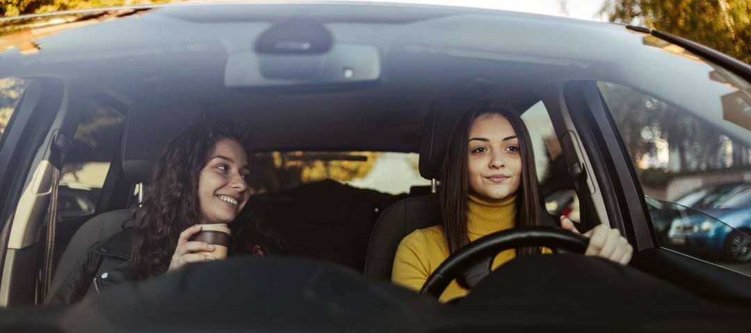 Two young women in a luxury car