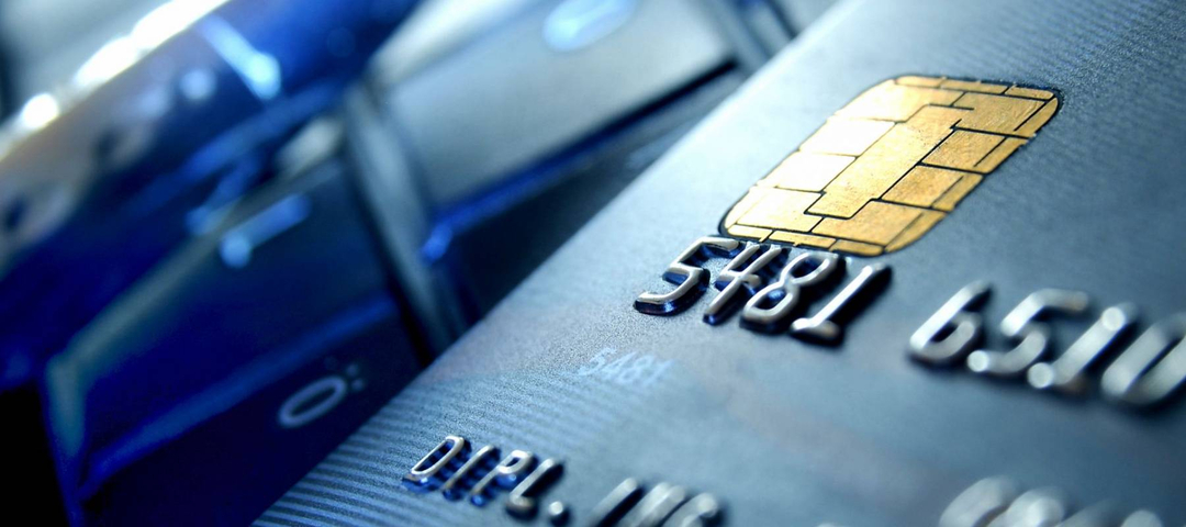 Credit card and ball pen on a laptop