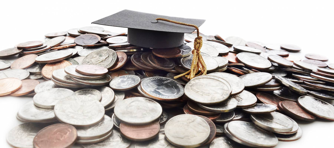 Graduation cap on a pile of change