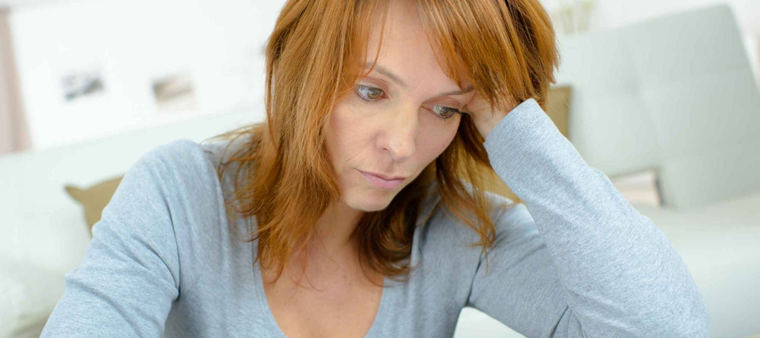 Lady using calculator, stressed