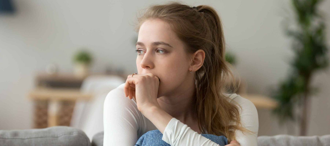 Head shot woman anxious worried millennial woman