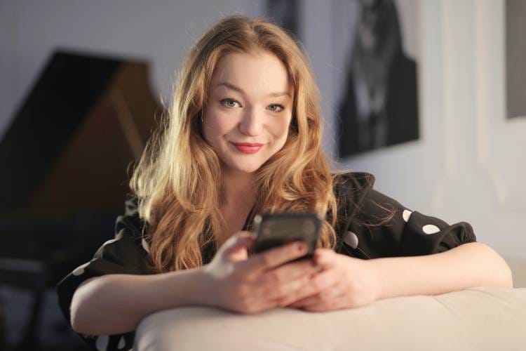 Smiling woman using her smartphone.
