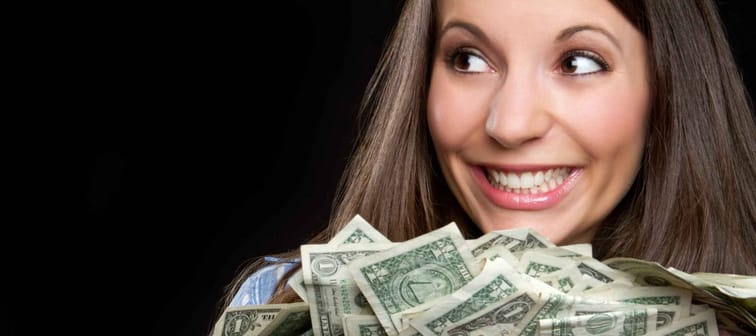 Beautiful smiling woman holding money