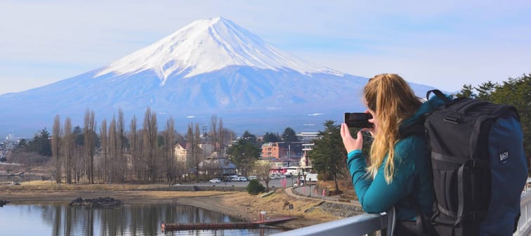Woman taking picture of Mt Fuji in Japan